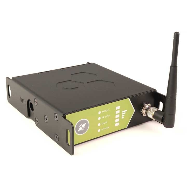 A black wireless communication device with a small antenna, metal casing, and a green label indicating lighting mode, RF link, data, and power status. The device rests on a white background.
