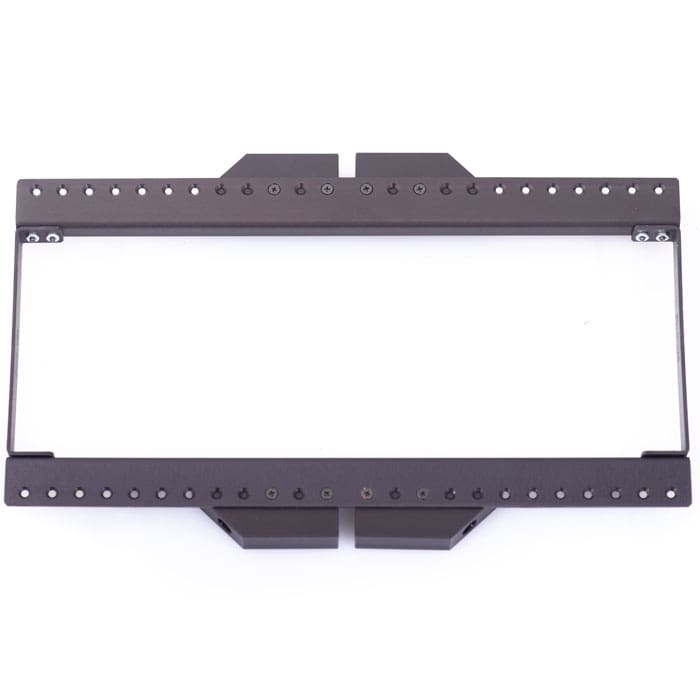 Rectangular black metal bracket or frame with multiple holes along its edges, often used in audio or video setups, viewed from above on a white background.