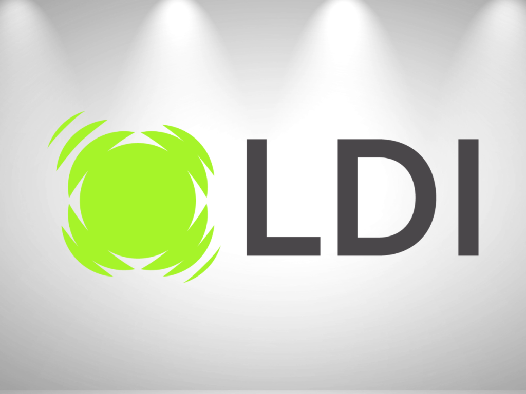 A logo with a bright green circular abstract design on the left, followed by the bold black letters LDI on a light gray background with three spotlights shining above.