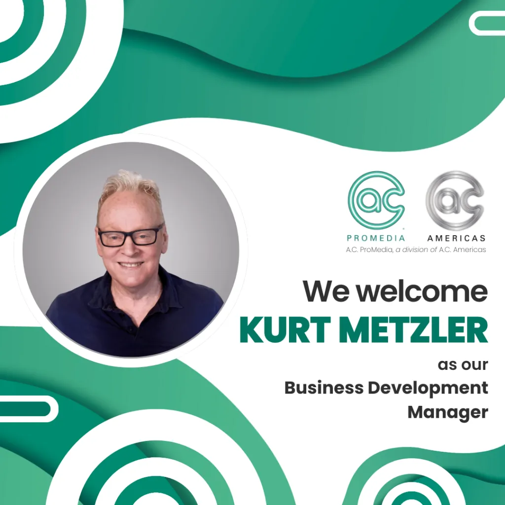 A welcome graphic with a photo of a smiling man wearing glasses. Text reads: We welcome Kurt Metzler as our Business Development Manager for audio and lighting. Logos for AC Promedia and AC Americas are at the top right, on a green abstract background.