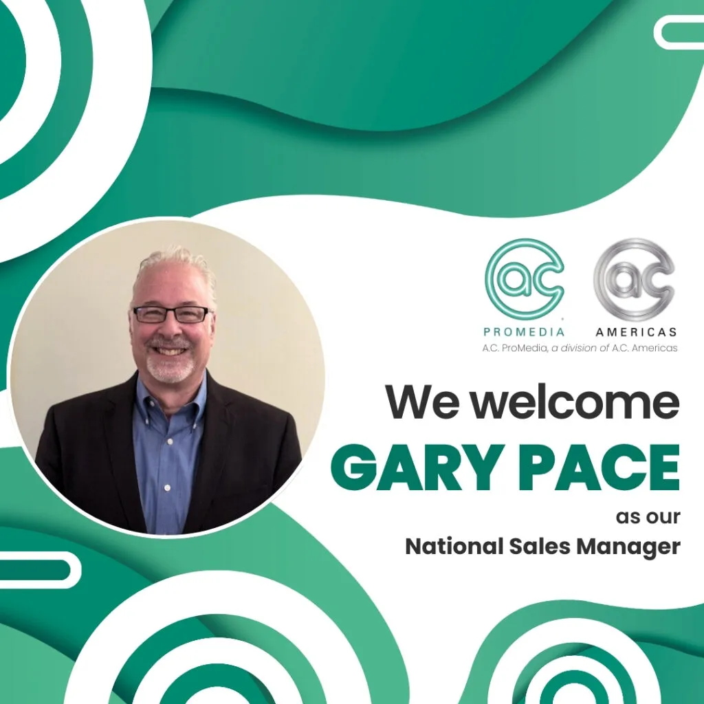 A smiling man with gray hair and glasses, wearing a dark blazer and shirt, is pictured with text welcoming Gary Pace as National Sales Manager for AC Promedia, a leader in audio, video, and lighting, alongside company logos on a green and white background.